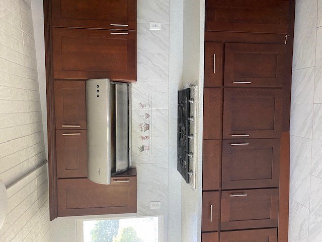 a kitchen with wooden cabinets and a wall mounted refrigerator