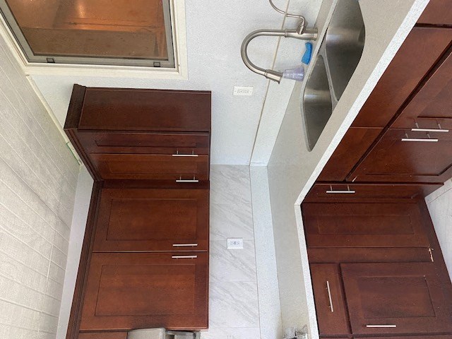 a bathroom with wooden cabinets and a sink
