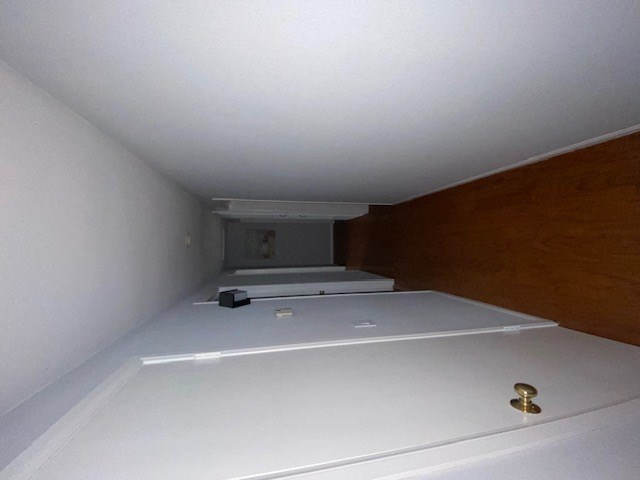 a bathroom with a white floor and a gold faucet