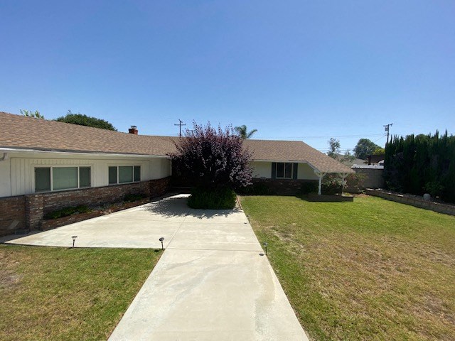 a white house with a driveway and a yard