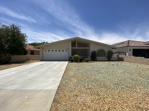 A modern house with a driveway in front.