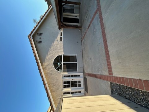 A building with a round window and a white door.