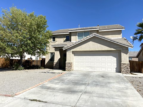 A house with a garage door and a driveway.