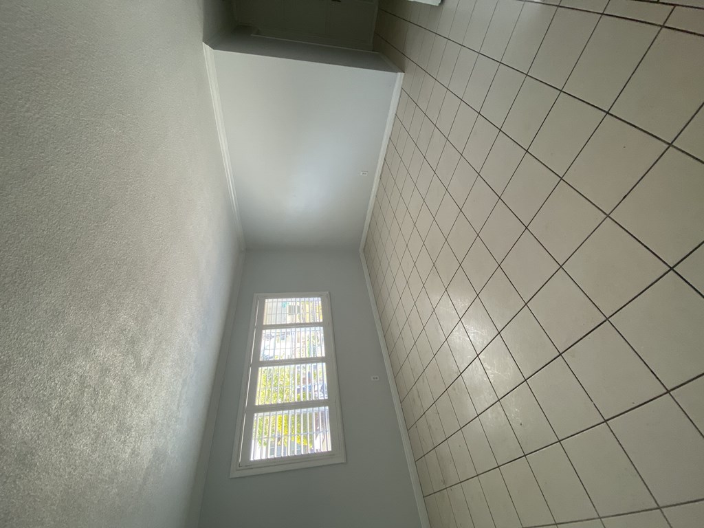A small window with a grid pattern on the wall.