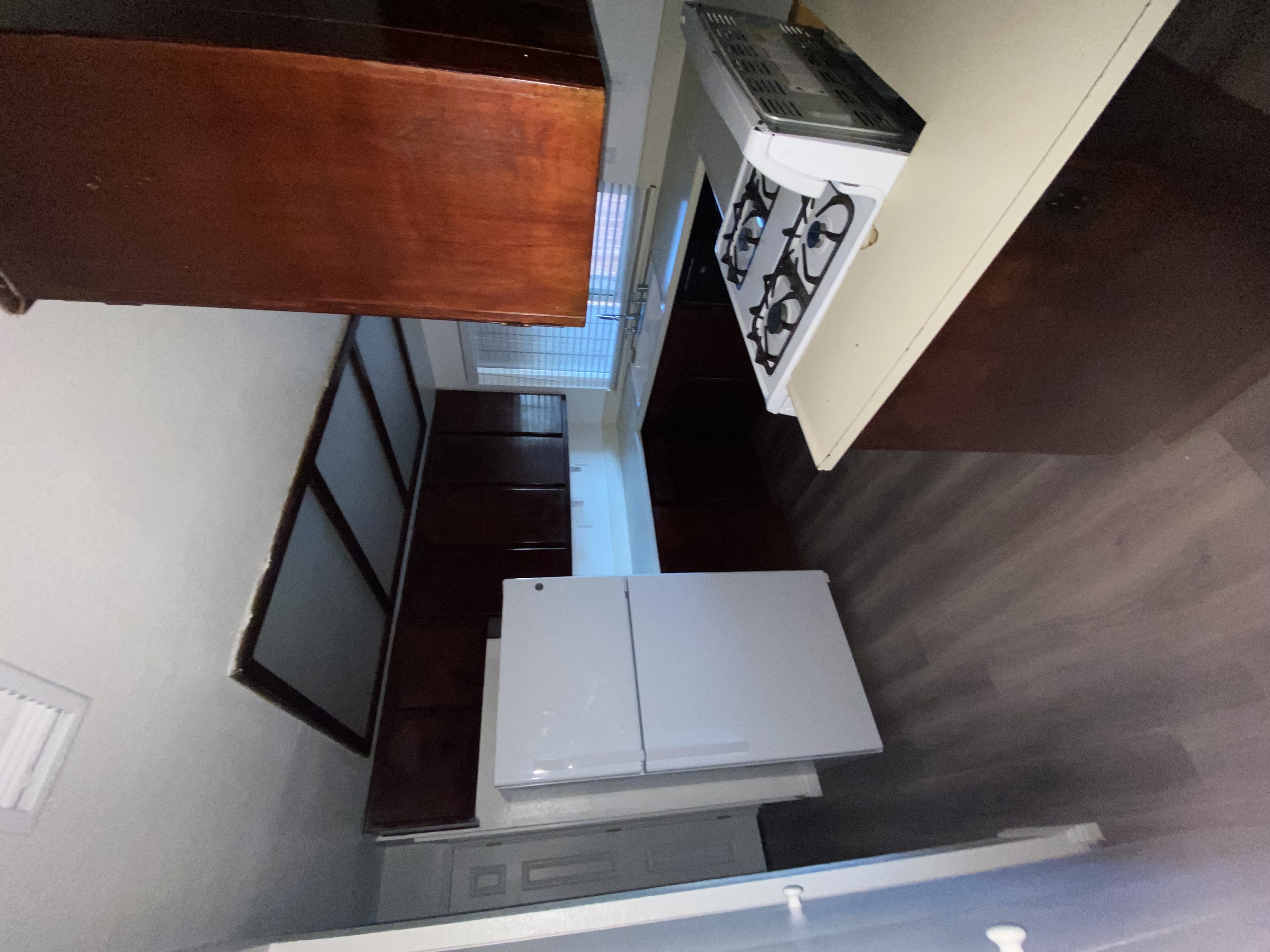 A kitchen with a stove top oven and a microwave.