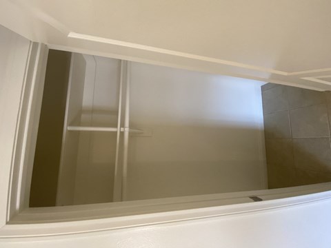 A white framed window in a room.
