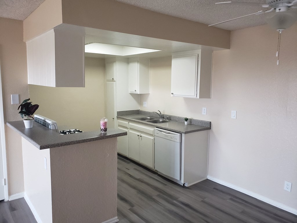 a kitchen with white cabinets and a white stove top oven