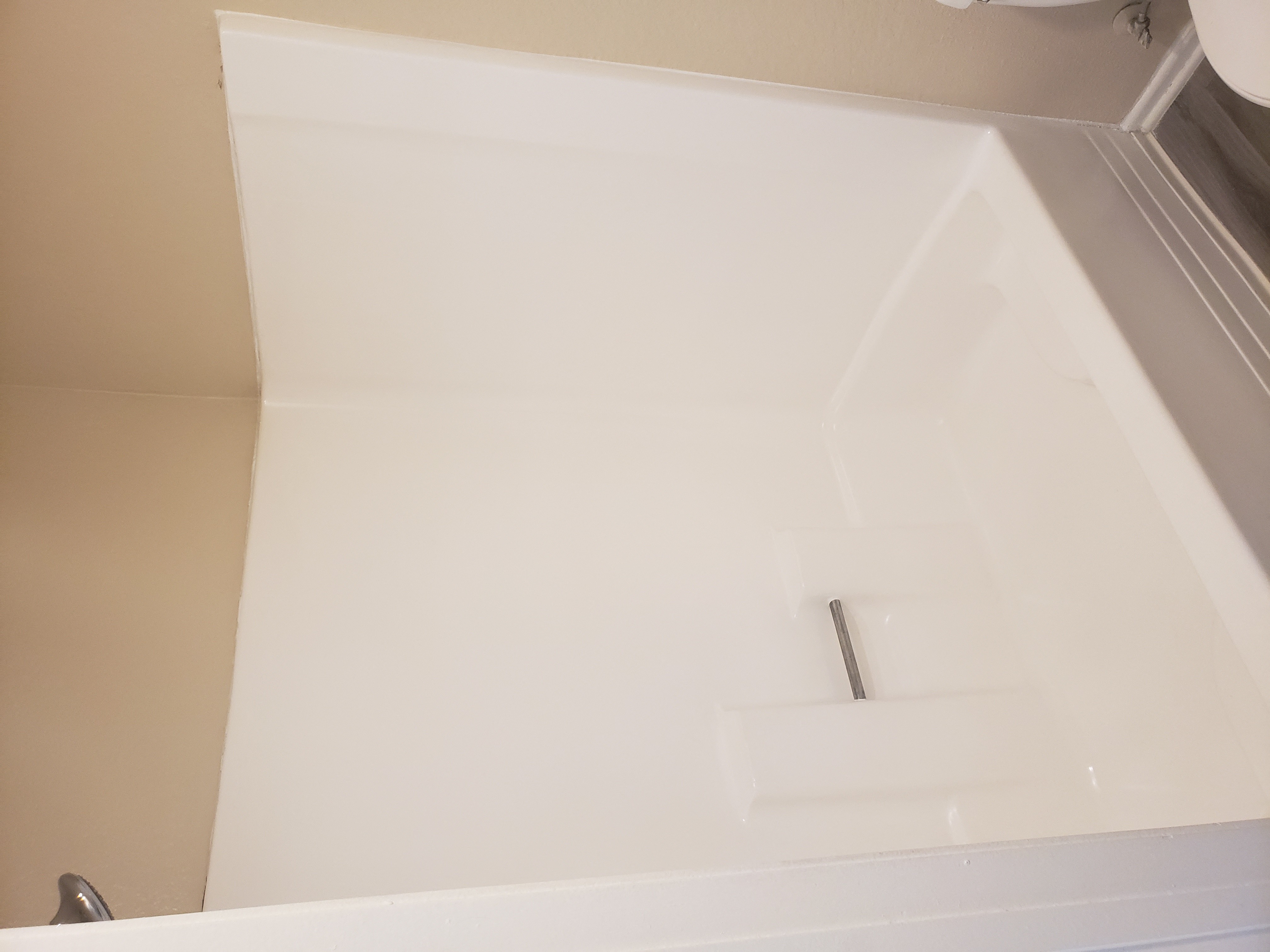 a white bathtub with a silver faucet