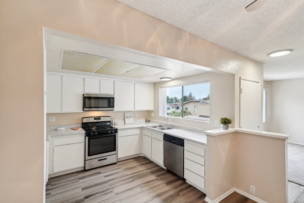 the preserve at ballantyne commons spacious kitchen with white cabinets and stainless steel appliances