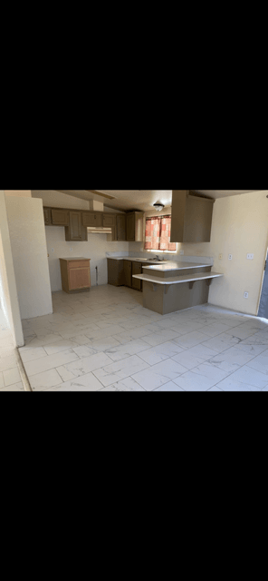 A kitchen with a counter and a sink.