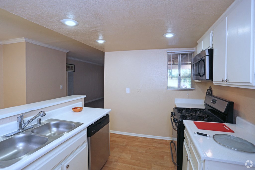 a kitchen with a sink and a stove and a microwave
