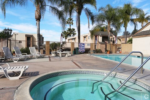 our apartments have a hot tub and a pool with palm trees