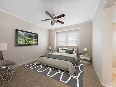 a bedroom with a bed and a ceiling fan