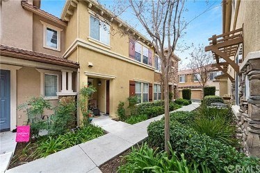 a street view of an apartment building with a sidewalk