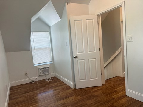 an empty room with a door and a window