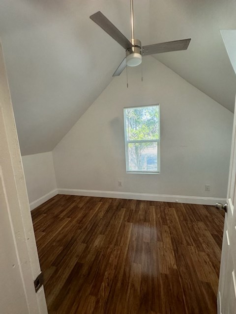 a room with hardwood floors and a ceiling fan