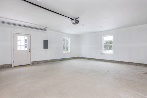 A room with a door, a window, and a ceiling fan.