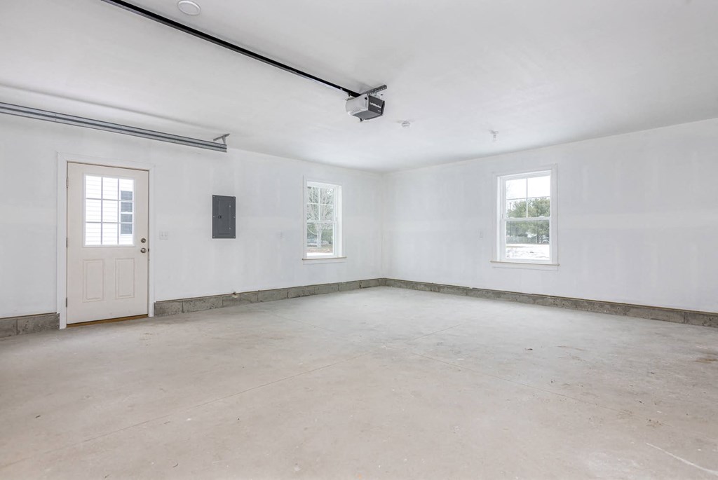 A room with a door, a window, and a ceiling fan.