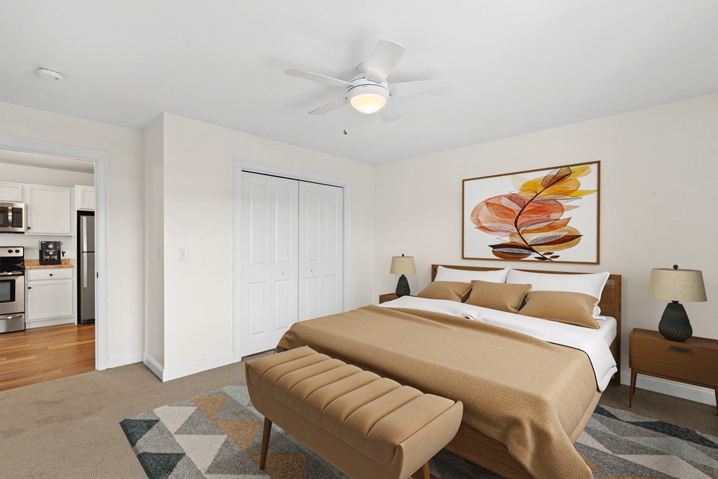 a bedroom with a bed and a ceiling fan