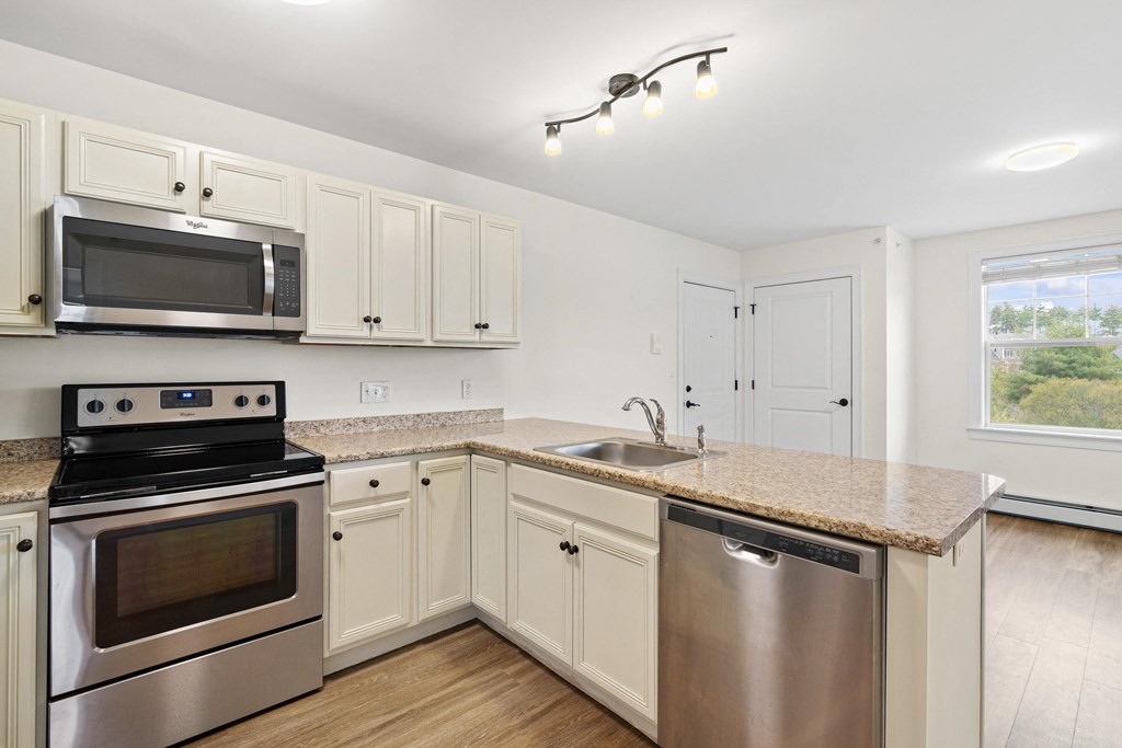 a kitchen with stainless steel appliances and a granite counter top