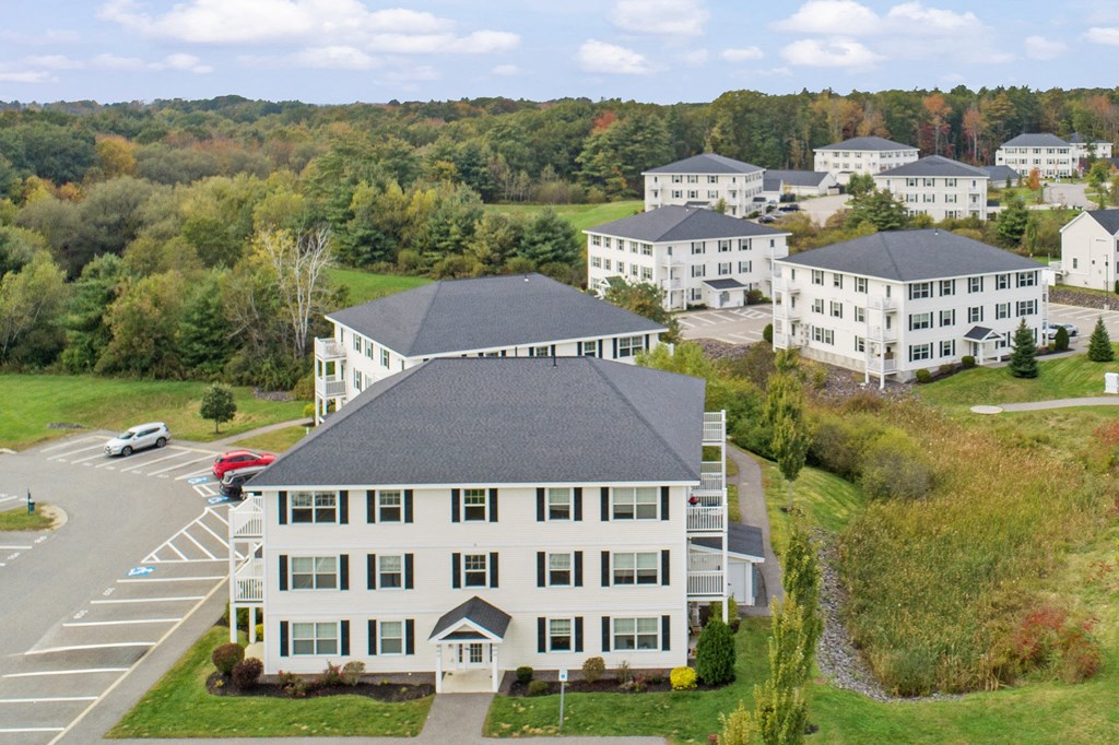 an aerial view of a large white building with other buildings in the background