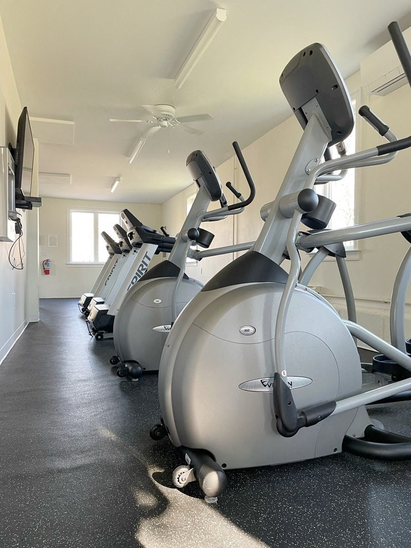 a gym with several machines in a row