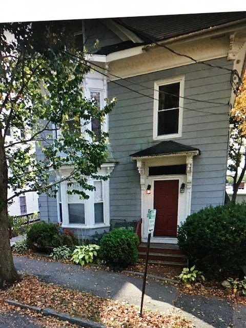 a house with a red door on a street