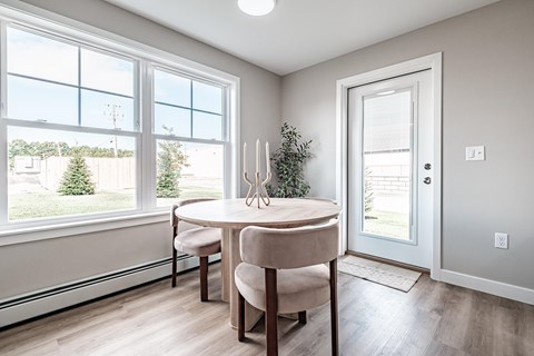 Dining area with round table and large windows at Windham Village Apartments, Windham, ME 04062