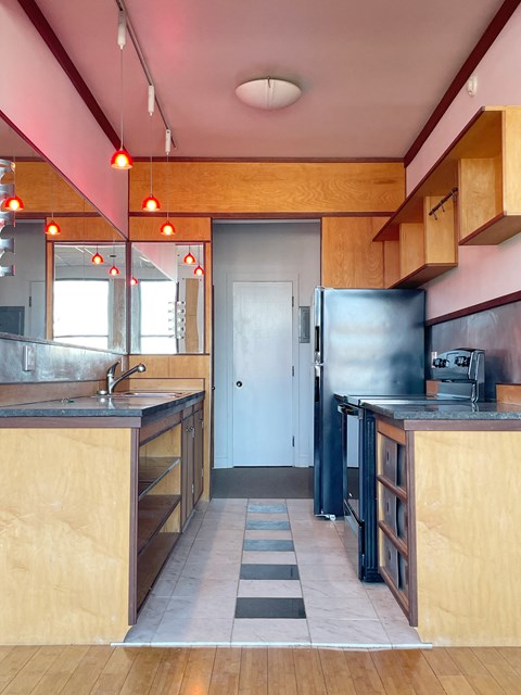 a kitchen with wooden cabinets and a refrigerator