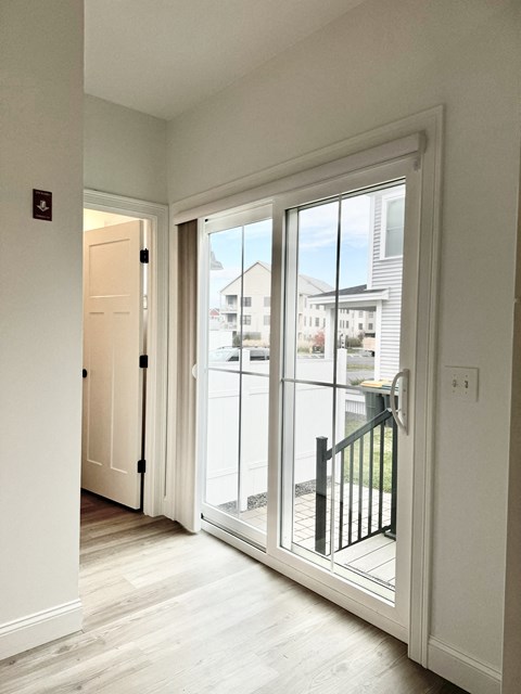 a view of the balcony from the living room of a new home