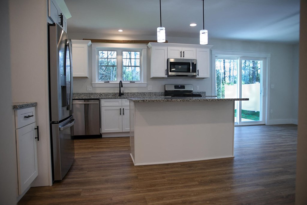 a kitchen with white cabinets and a counter top