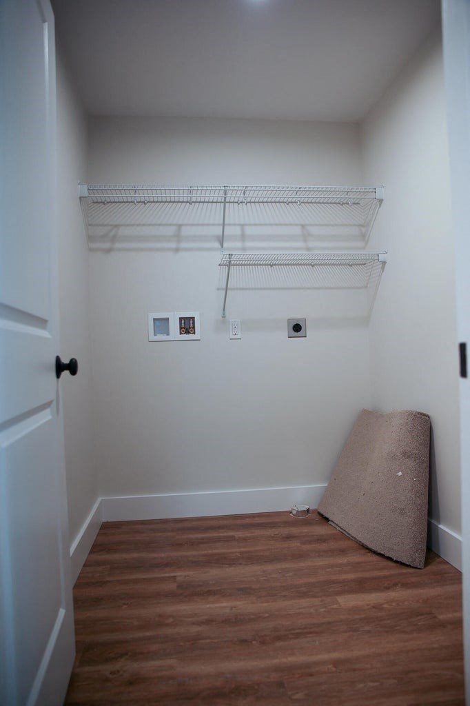 a bedroom with a futon and a shelf on the wall