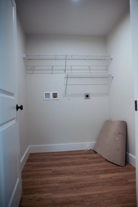 a bedroom with a futon and a shelf on the wall