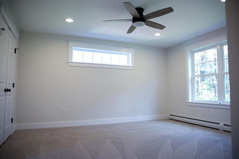 a living room with a ceiling fan and a window