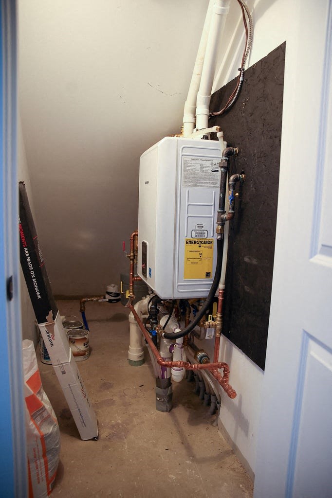 the back of a gas furnace in a wall