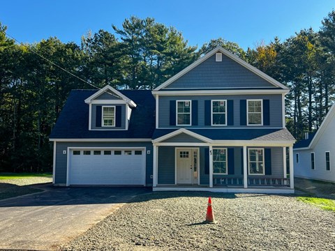 a blue house with an orange cone in front of it