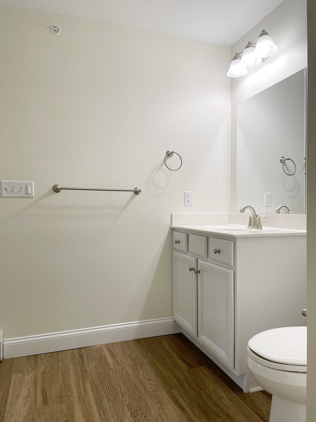 a bathroom with a toilet and a sink and a shower