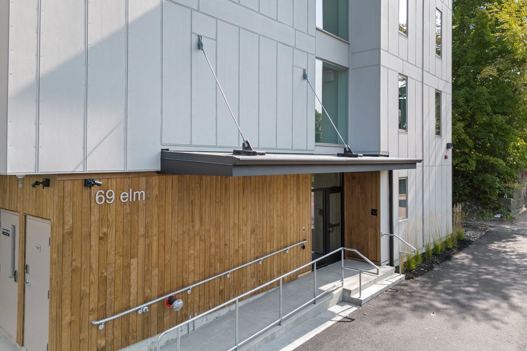 the side of a building with a wooden wall and stairs