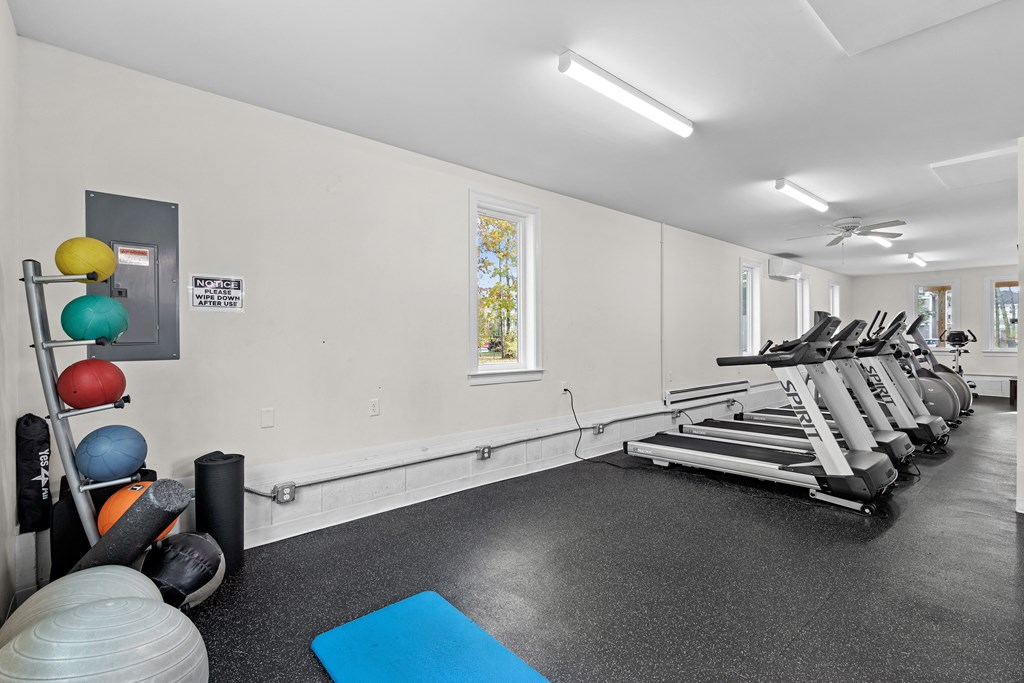 the gym with treadmills and weights at the belgard apartments