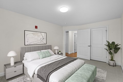 Bedroom with gray headboard and white bedding at Autumn Woods Apartments, Maine, 04092