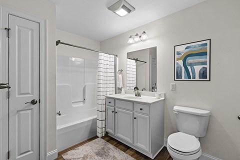 Bathroom with white vanity and tub shower combo at Autumn Woods Apartments, Westbrook, ME