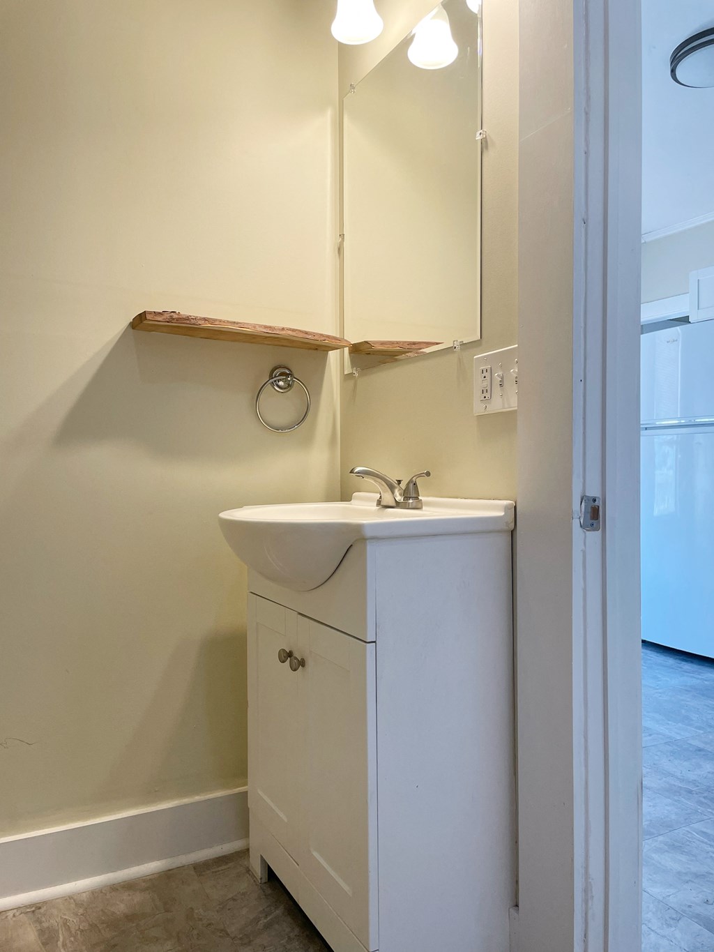 an empty bathroom with a sink and a mirror