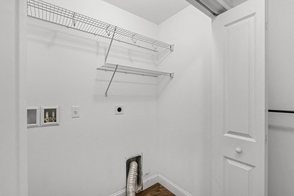 a white room with a closet and a shelf on the wall