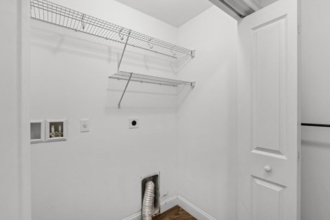 A white wall with a vent and a door.