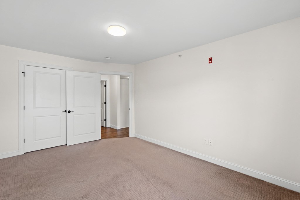 an empty living room with white walls and white doors