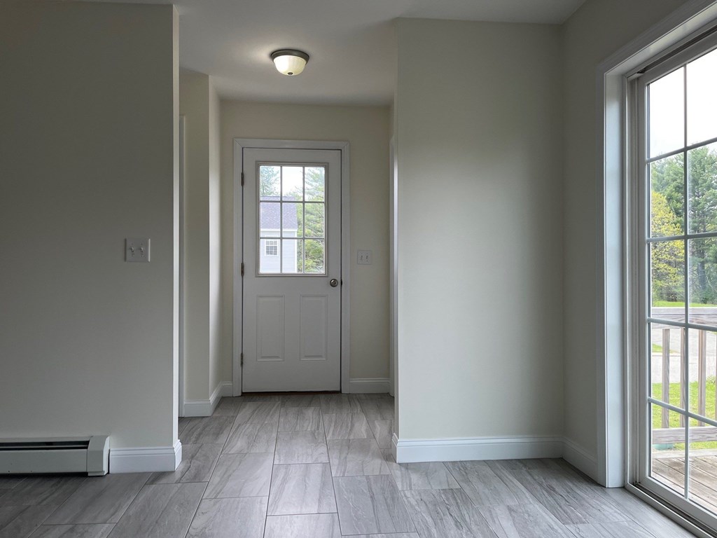 A white door is in the middle of a hallway with a light on the ceiling.