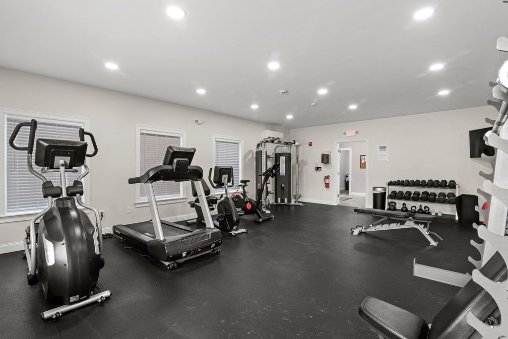 the gym with treadmills and weights at the belgard apartments