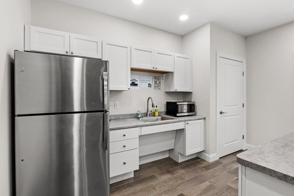 a kitchen with stainless steel appliances and white cabinets
