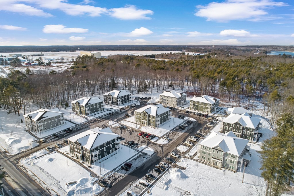 an aerial view of a group of buildings in the snow