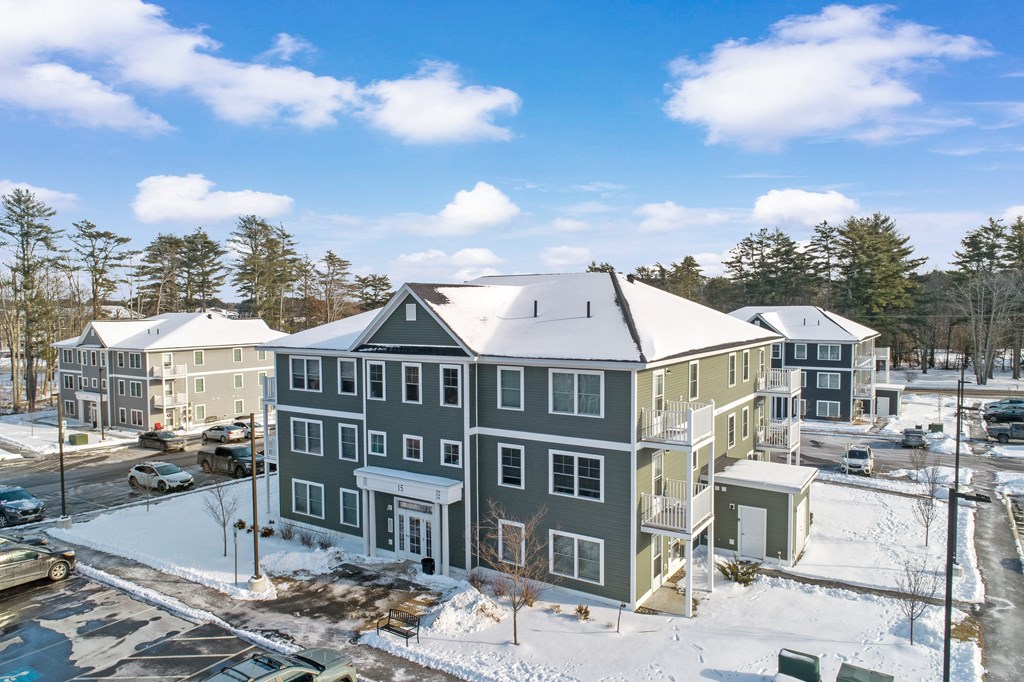 an aerial view of an apartment building in the snow